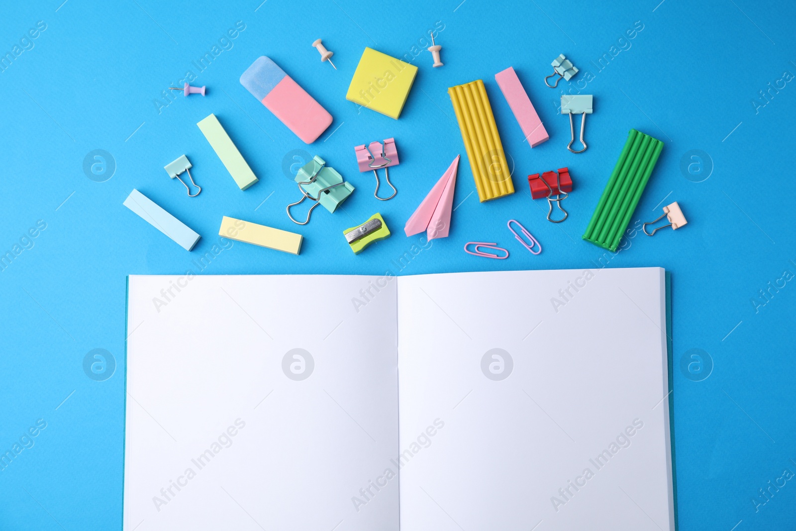 Photo of Flat lay composition with school stationery on light blue background. Back to school