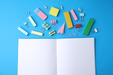 Photo of Flat lay composition with school stationery on light blue background. Back to school