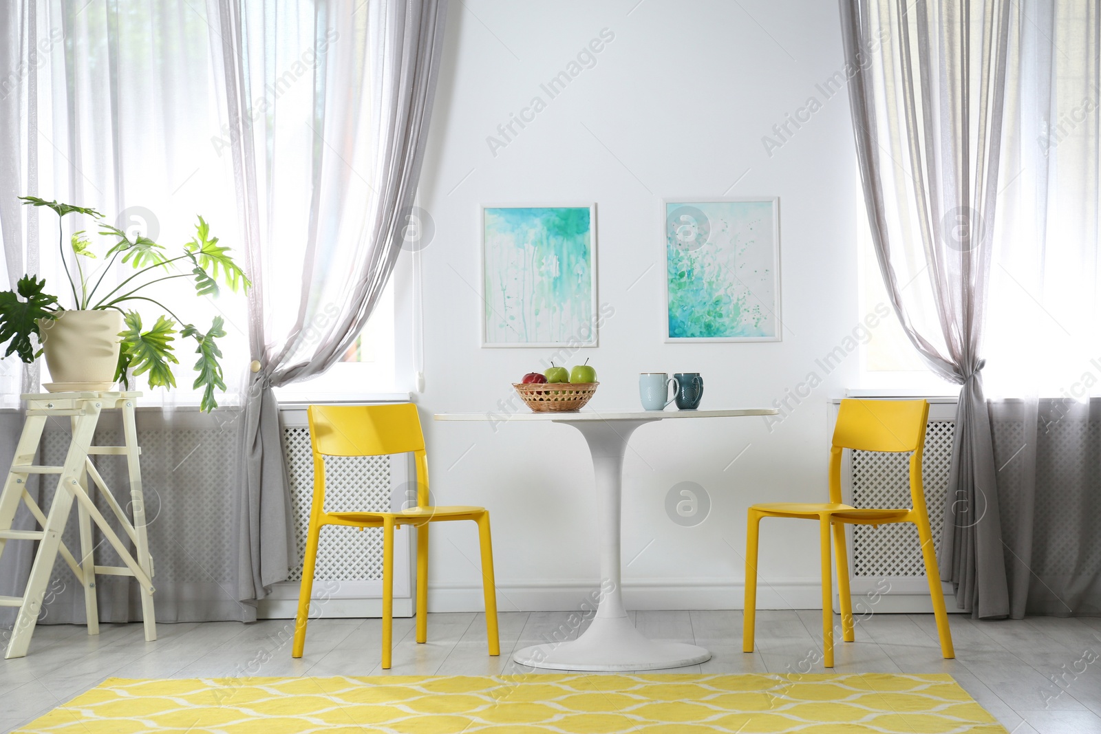 Photo of Room with comfortable table, chairs and stylish decor. Idea for interior design