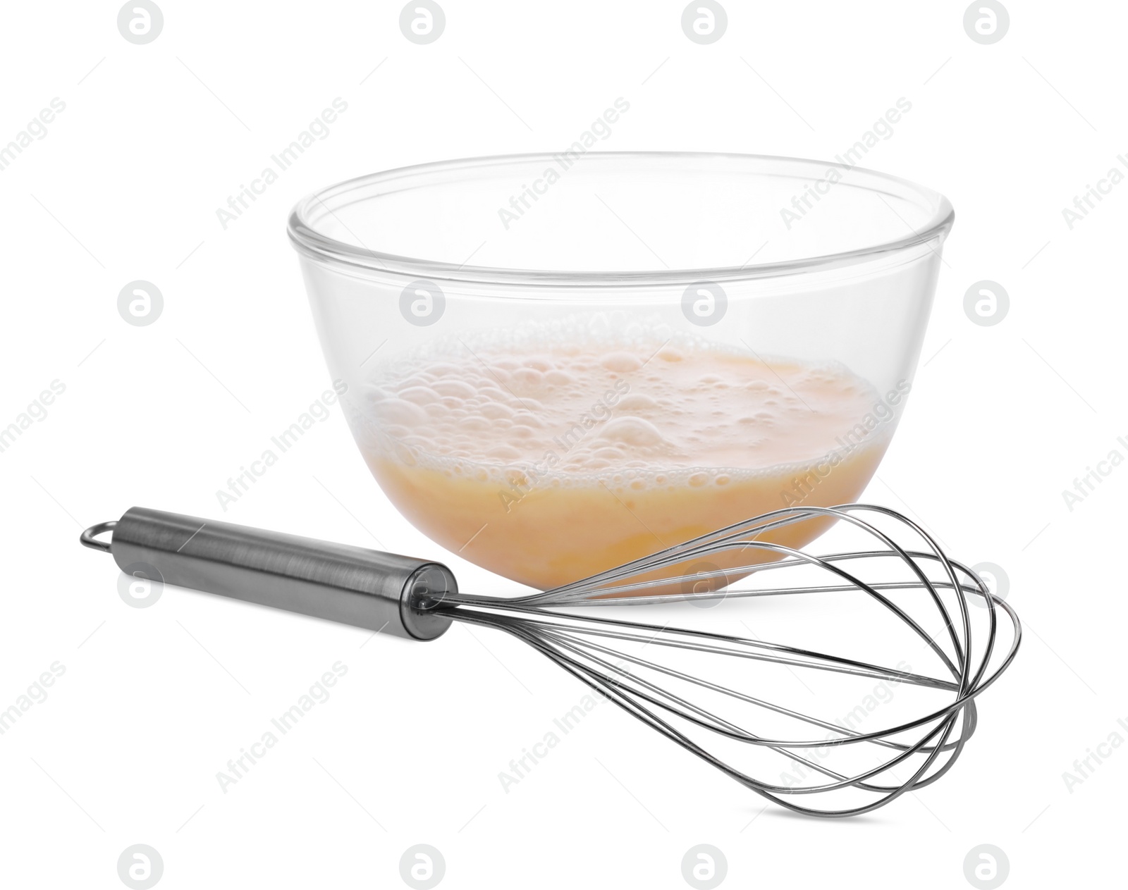 Photo of Beaten eggs in glass bowl and whisk isolated on white