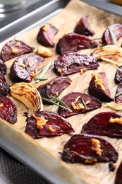 Photo of Roasted beetroot slices in baking dish, closeup