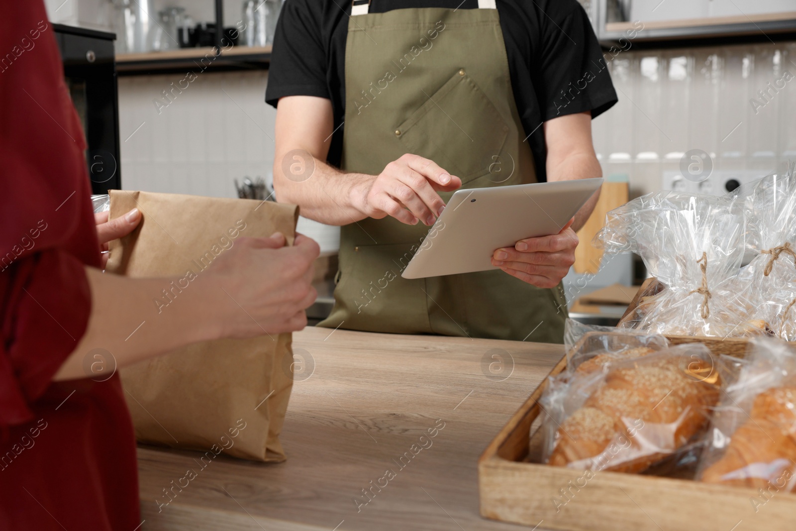 Photo of Woman buying fresh pastries in bakery shop, closeup