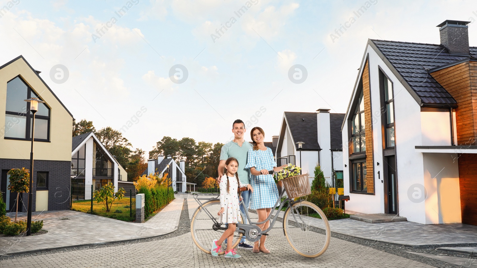 Image of Happy family smiling near their new house