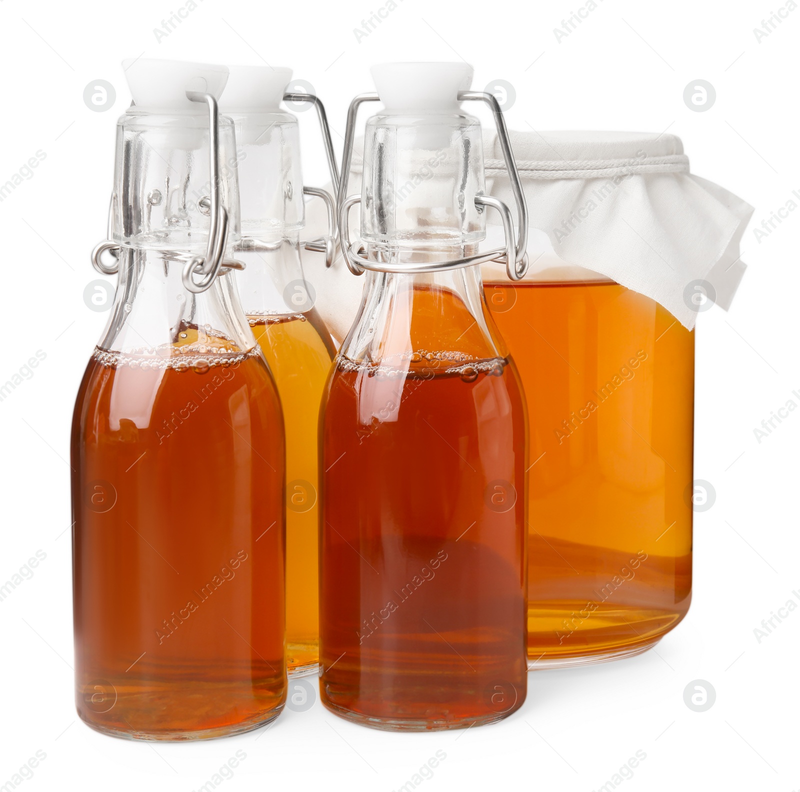 Photo of Tasty kombucha in glass jar and bottles isolated on white