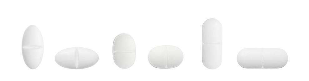 Image of Set of different pills in row isolated on white