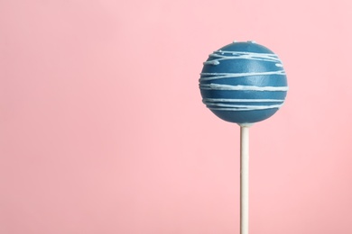 Photo of Bright delicious cake pop on color background. Space for text