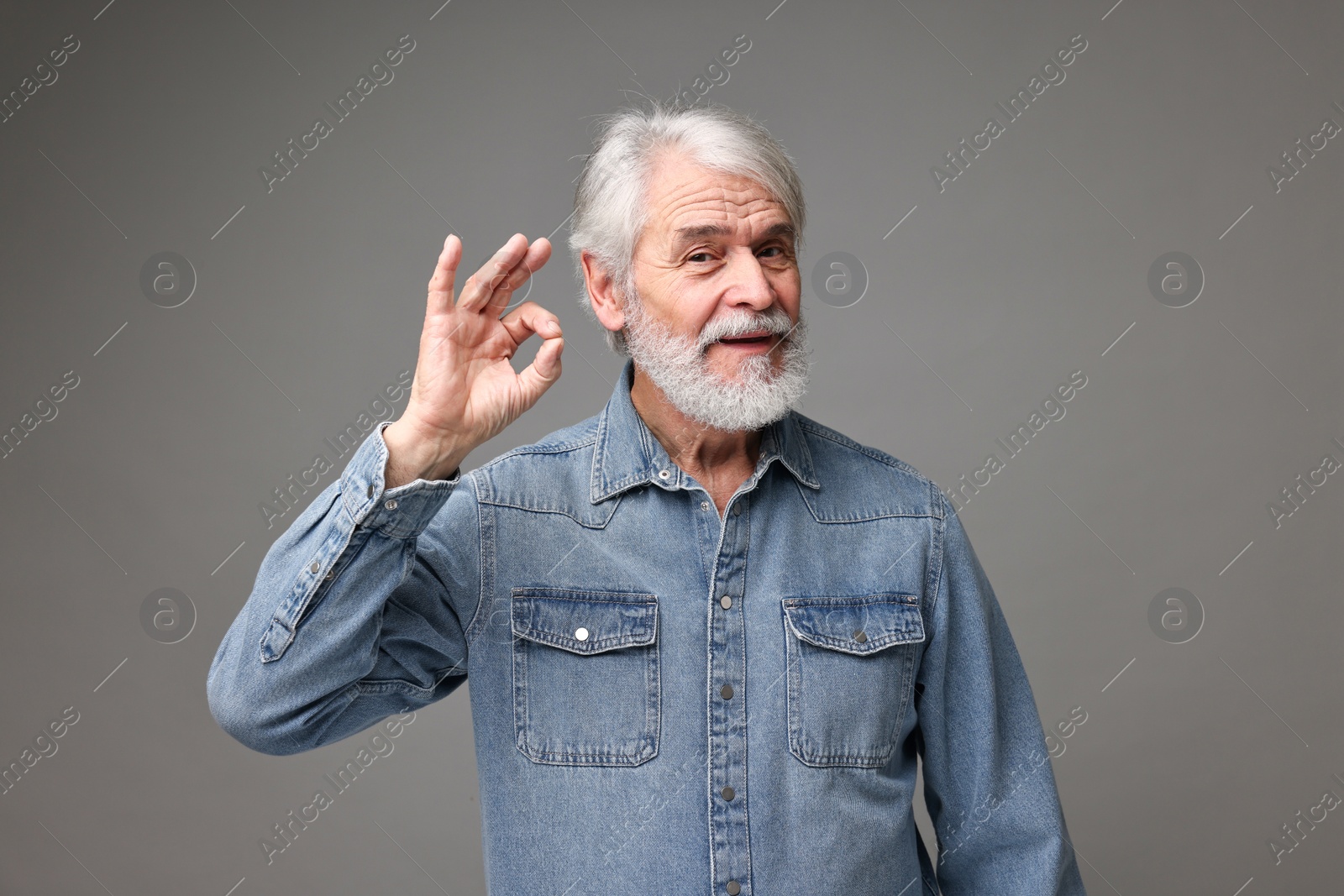 Photo of Senior man with mustache on grey background