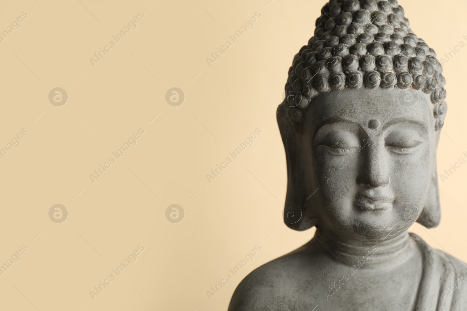 Photo of Beautiful stone Buddha sculpture on beige background. Space for text