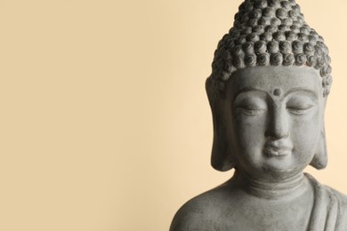 Photo of Beautiful stone Buddha sculpture on beige background. Space for text