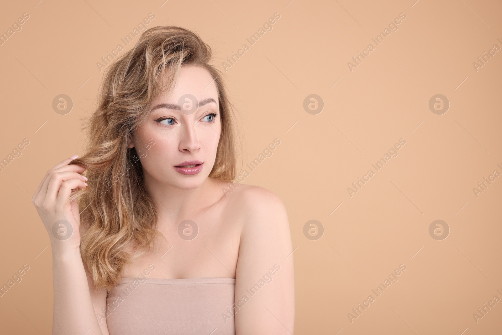 Photo of Portrait of beautiful woman on beige background. Space for text