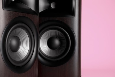 Photo of Wooden sound speakers on pink background, closeup. Space for text