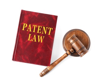 Image of Patent Law book and wooden gavel on white background, top view