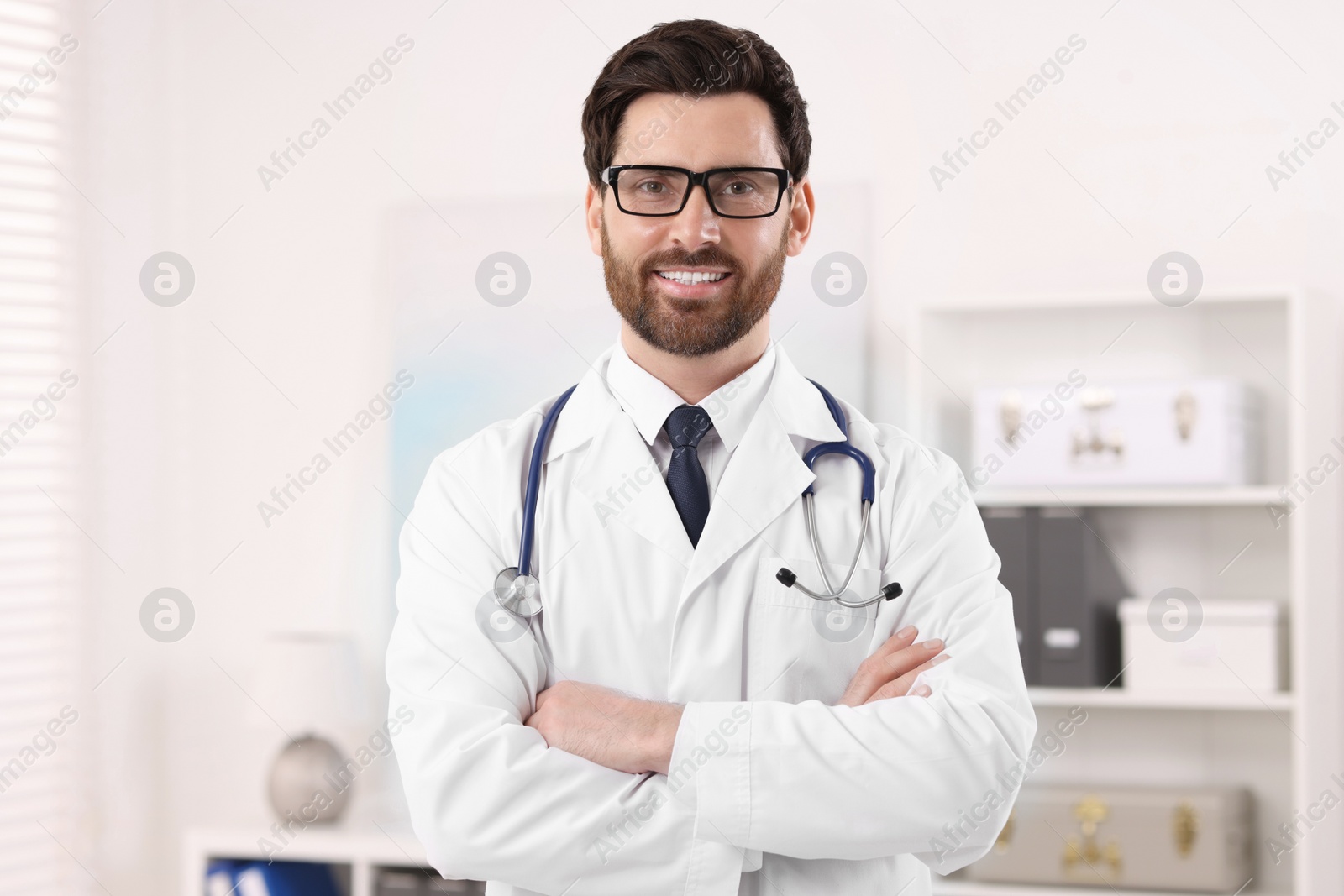 Photo of Medical consultant with glasses and stethoscope in clinic