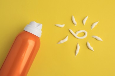 Photo of Drawing of sun and bottle with sunscreen on yellow background, top view. Skin protection