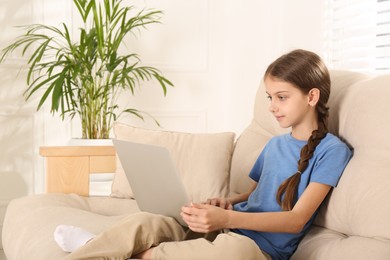 Photo of Girl with laptop on sofa at home