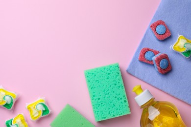 Photo of Flat lay composition with dishwasher detergent pods and tablets on pink background, space for text
