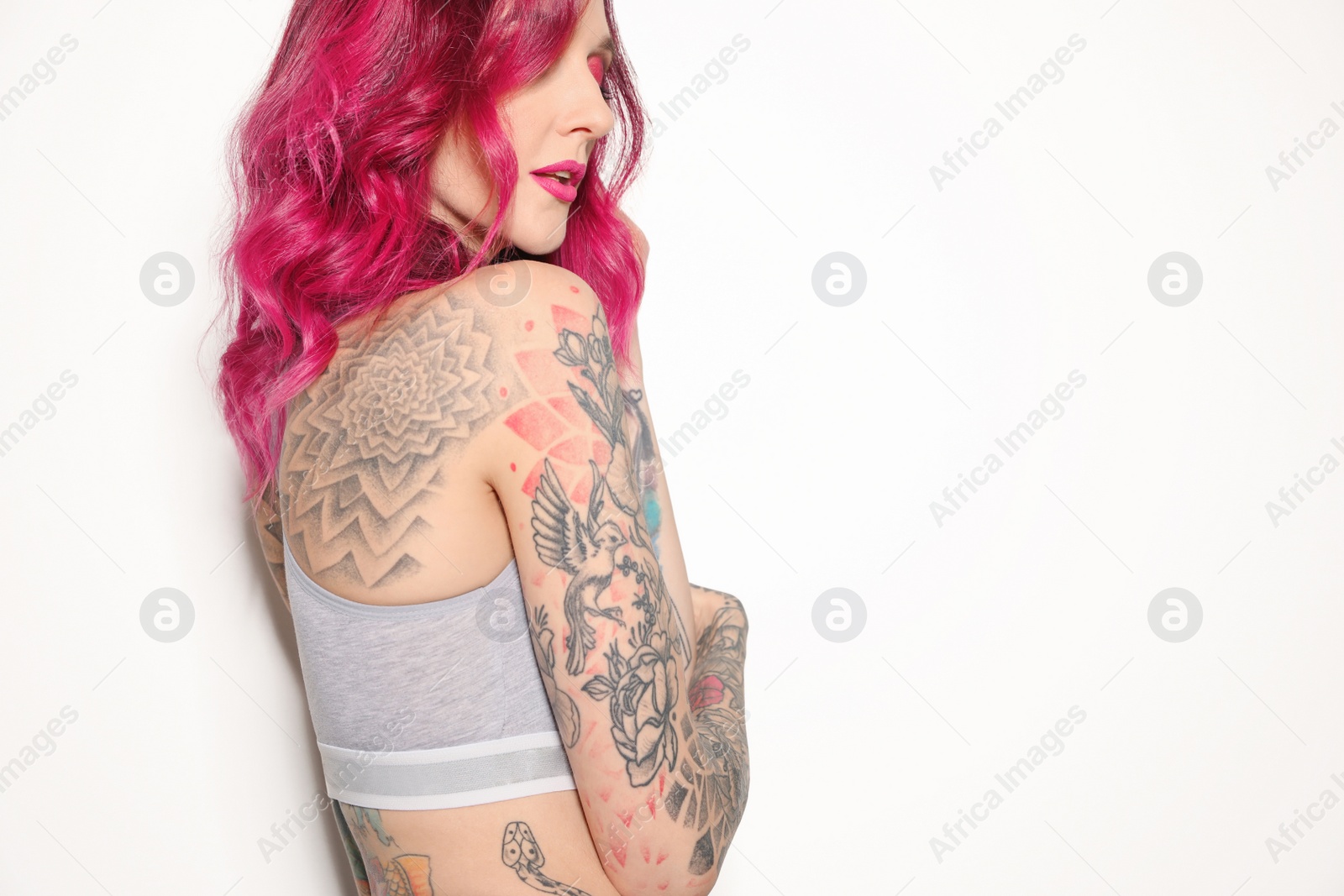 Photo of Beautiful woman with tattoos on body against white background. Space for text