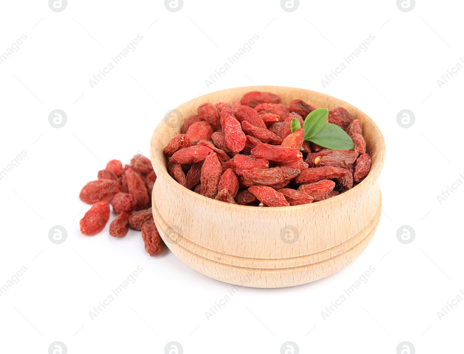 Photo of Wooden bowl with tasty dried goji berries and leaves on white background