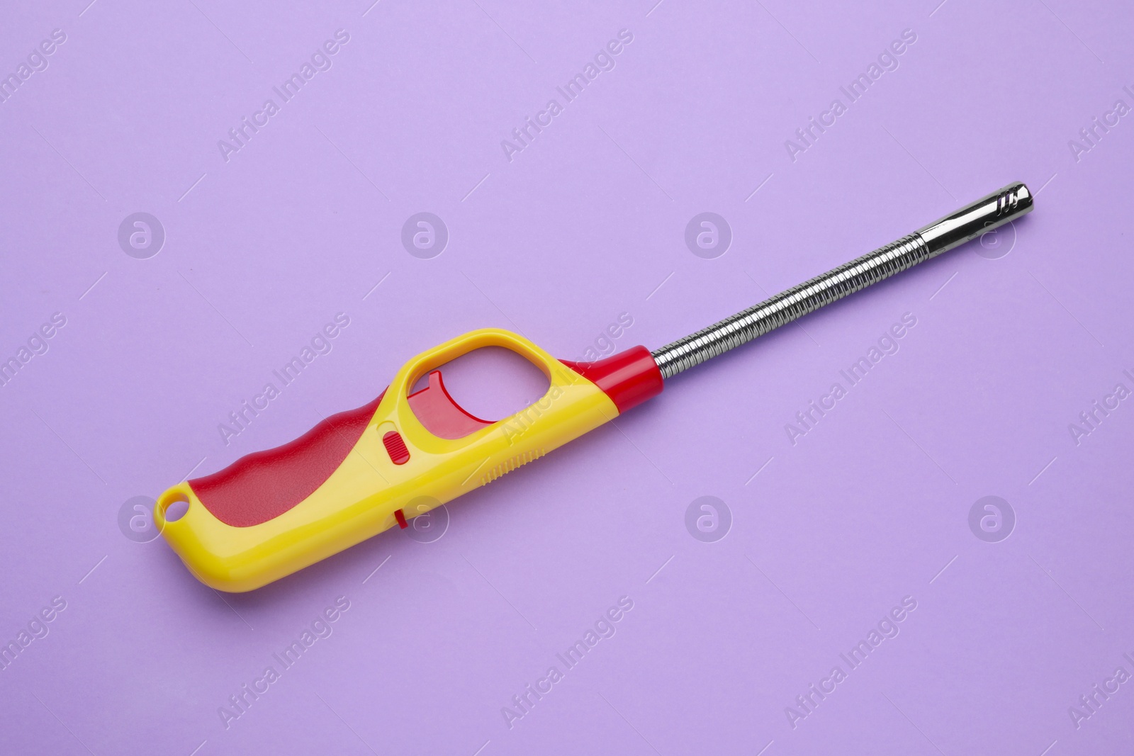 Photo of One gas lighter on violet background, top view