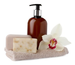 Soap bars, dispenser and terry towel on white background