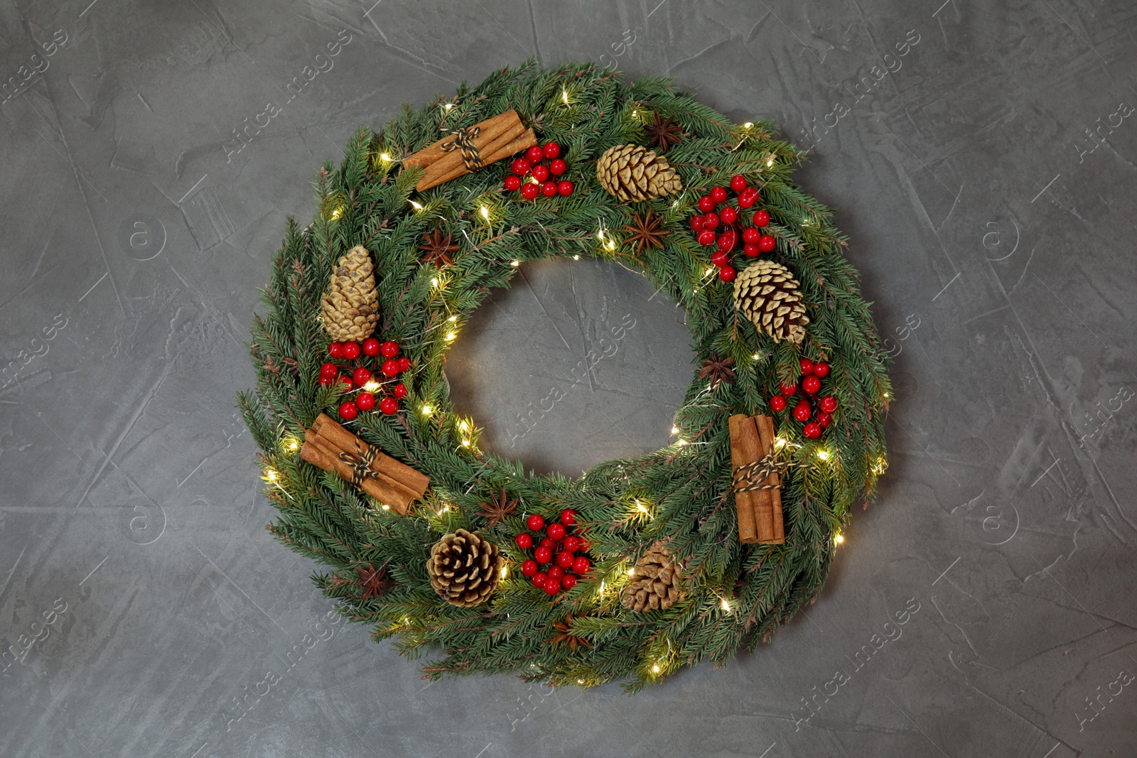 Photo of Beautiful Christmas wreath on grey background, top view