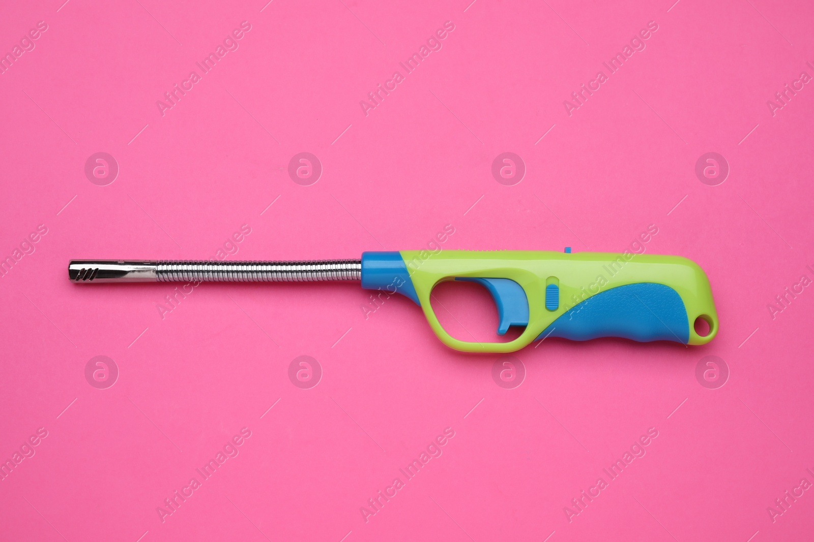 Photo of One gas lighter on pink background, top view