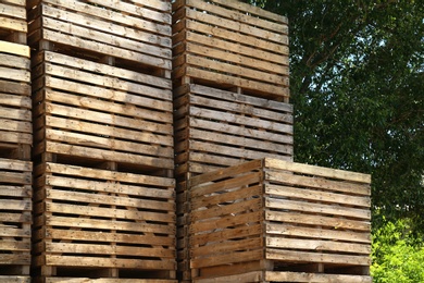 Photo of Pile of empty wooden crates outdoors on sunny day
