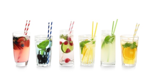 Photo of Glasses with tasty lemonades on white background