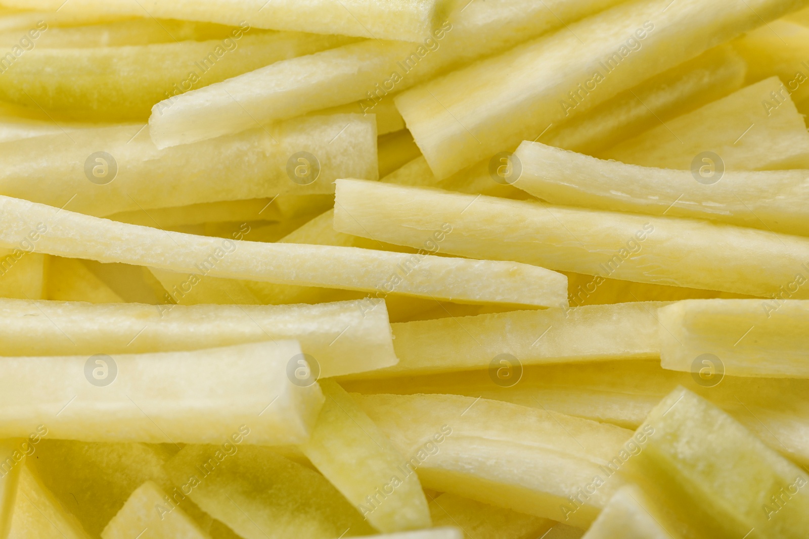 Photo of Raw white carrot sticks as background, closeup