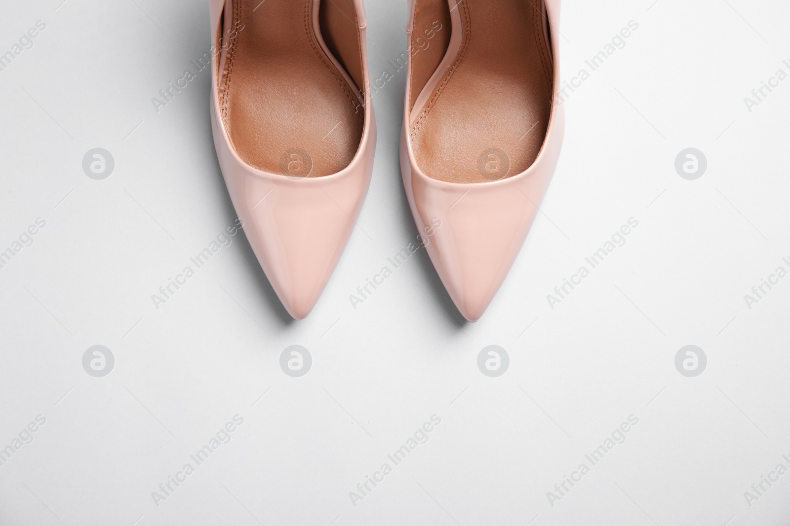 Photo of Pair of beautiful shoes and space for text on light background, top view