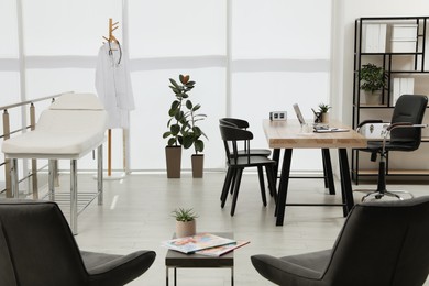 Photo of Modern medical office interior with doctor's workplace