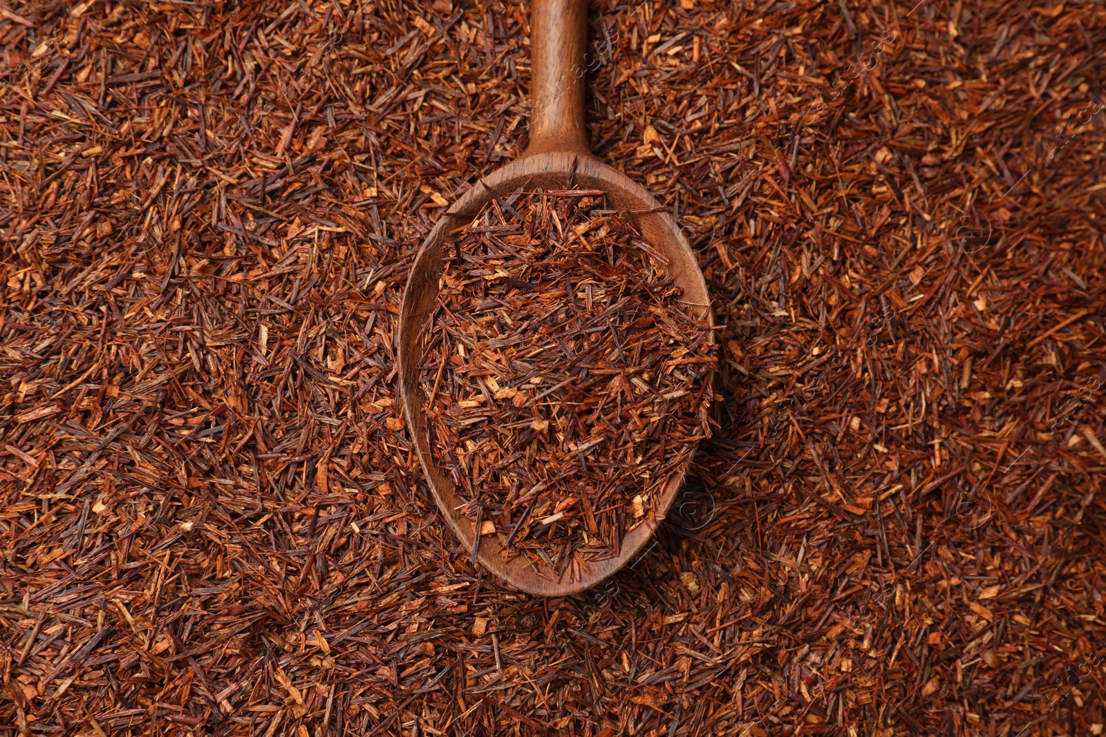 Photo of Rooibos tea and wooden spoon, top view