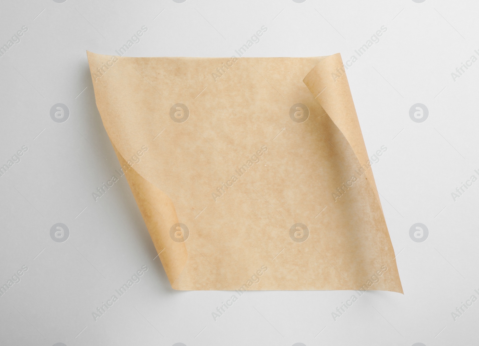 Photo of Sheet of brown baking paper on white background, top view