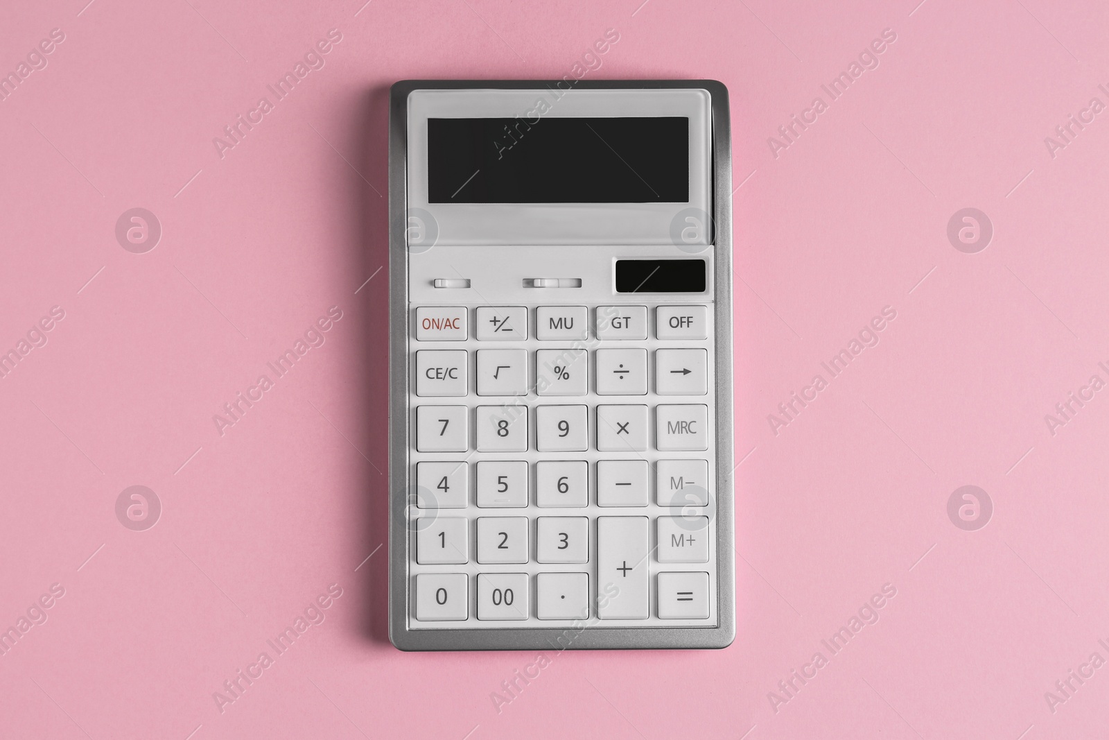 Photo of White calculator on pink background, top view