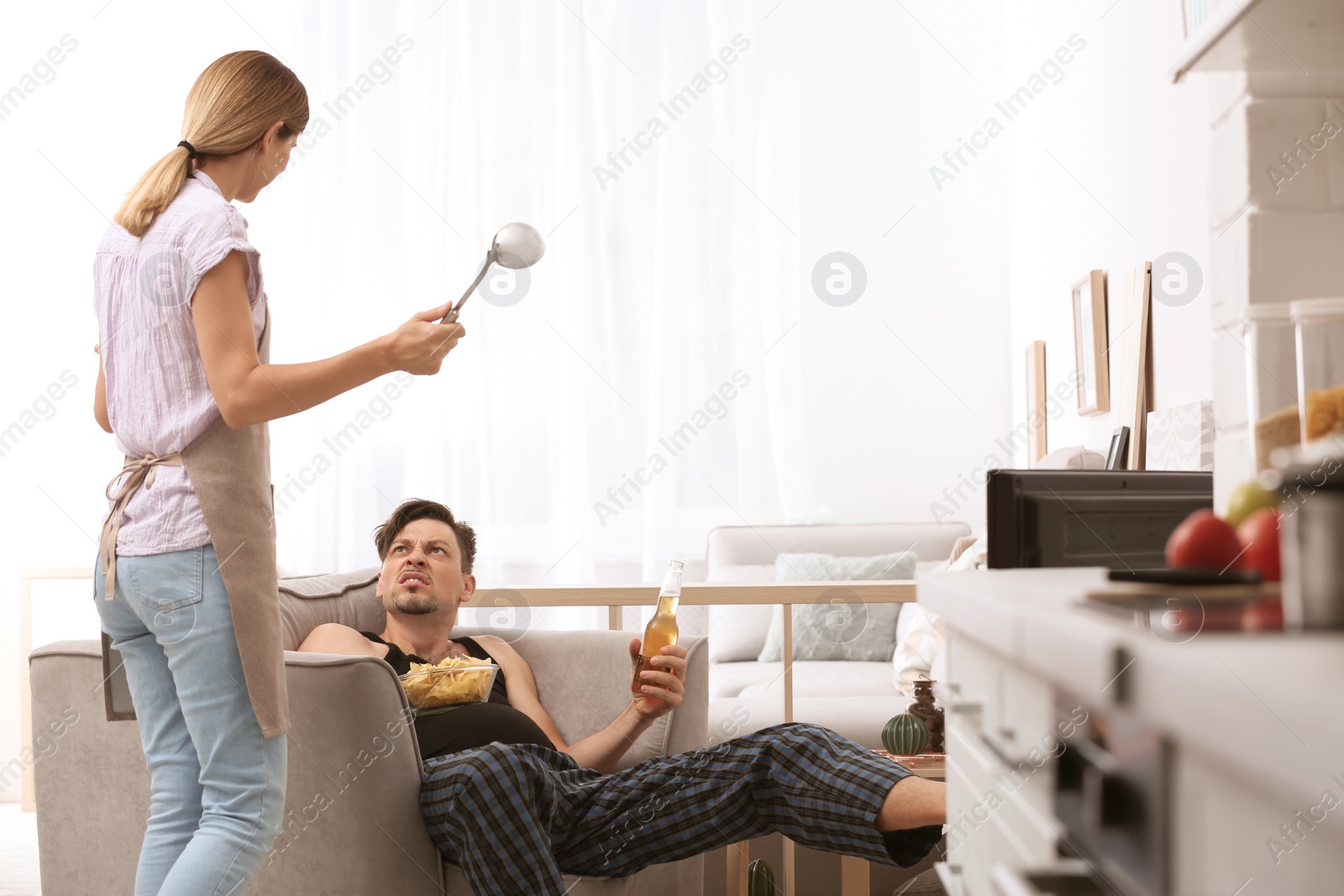 Photo of Lazy husband quarrelling with hardworking wife at home