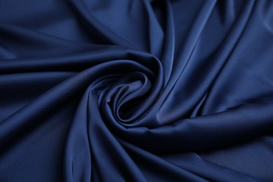 Crumpled dark blue silk fabric as background, top view