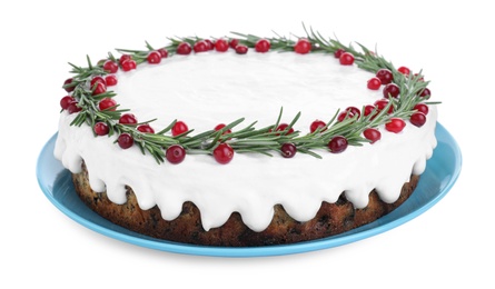 Photo of Traditional Christmas cake decorated with rosemary and cranberries isolated on white