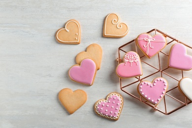 Photo of Flat lay composition with decorated heart shaped cookies and space for text on table