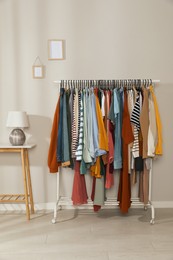 Rack with stylish clothes indoors. Fast fashion