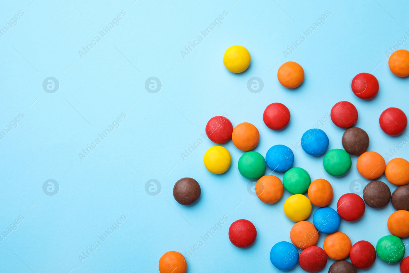 Photo of Tasty glazed candies and space for text on color background, top view