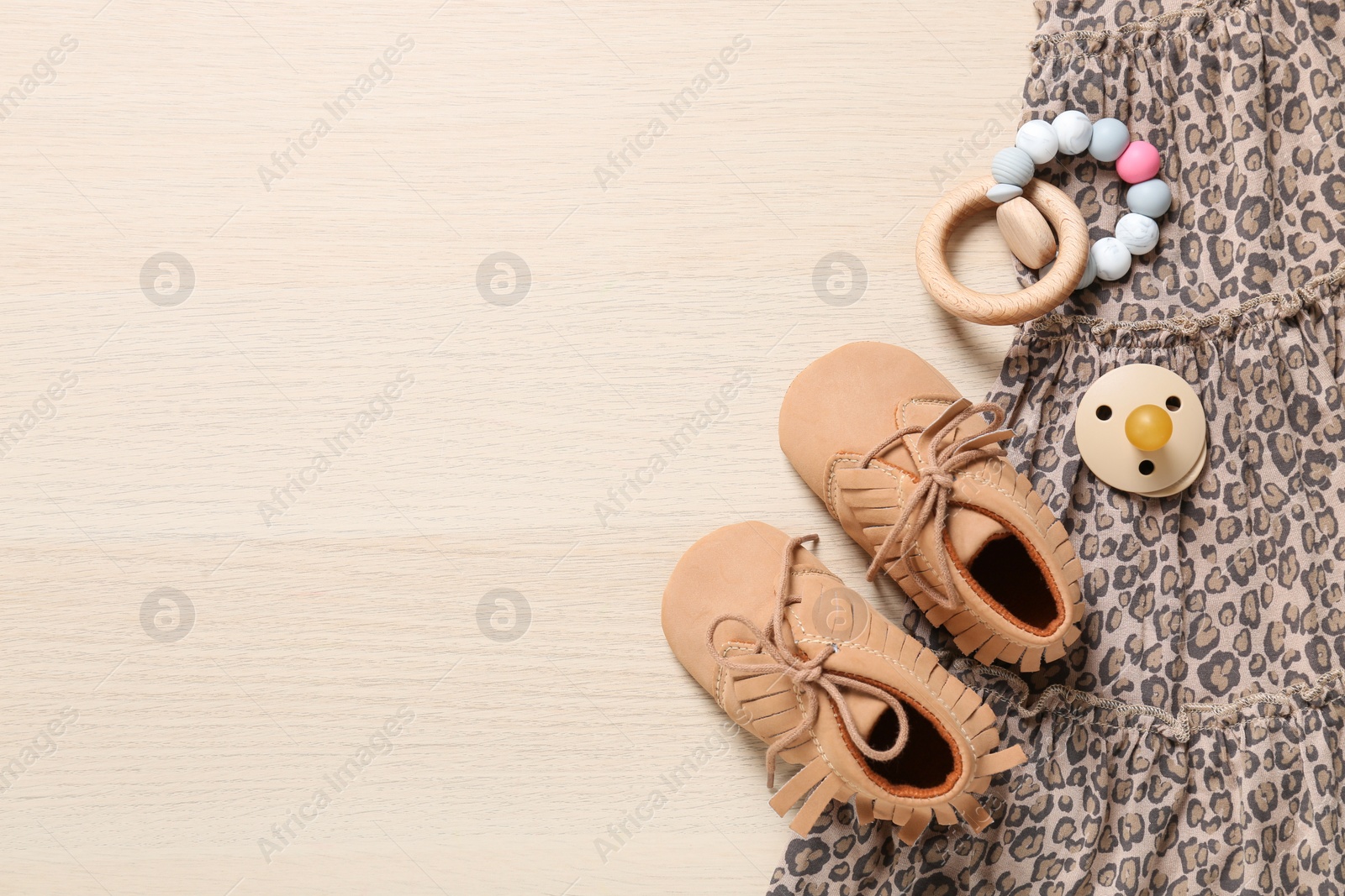 Photo of Flat lay composition with cute baby outfit on wooden background