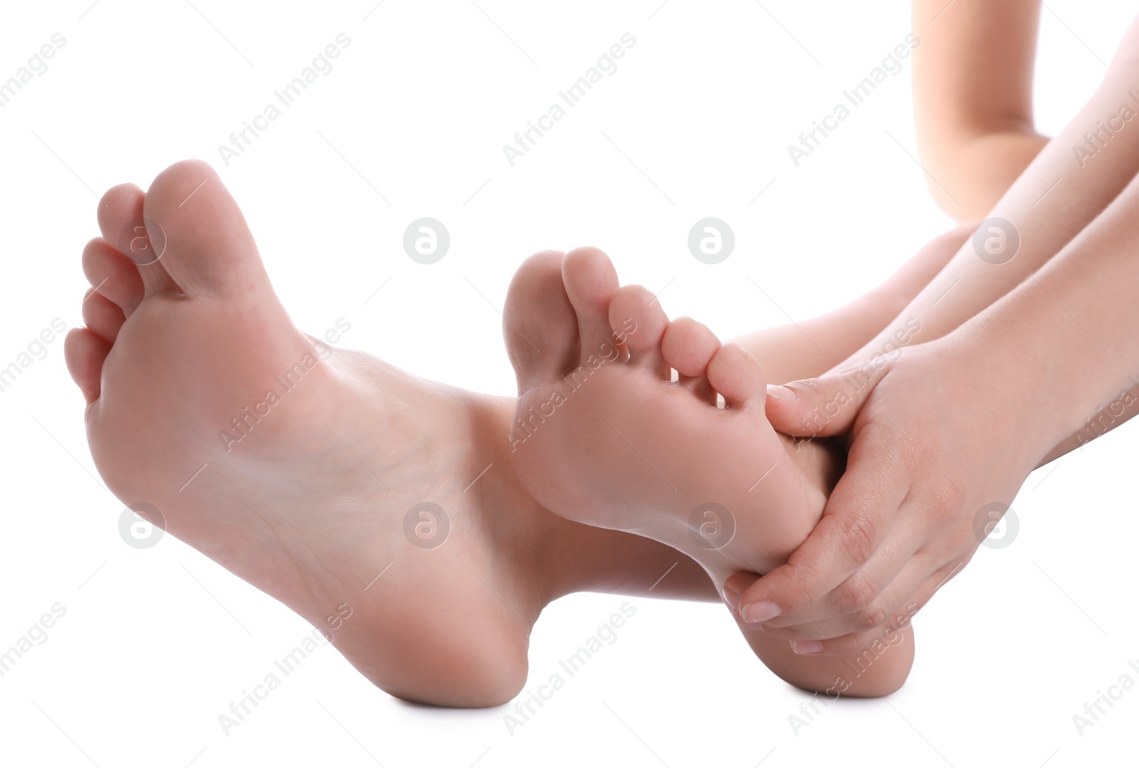 Photo of Young woman suffering from pain in foot on white background, closeup