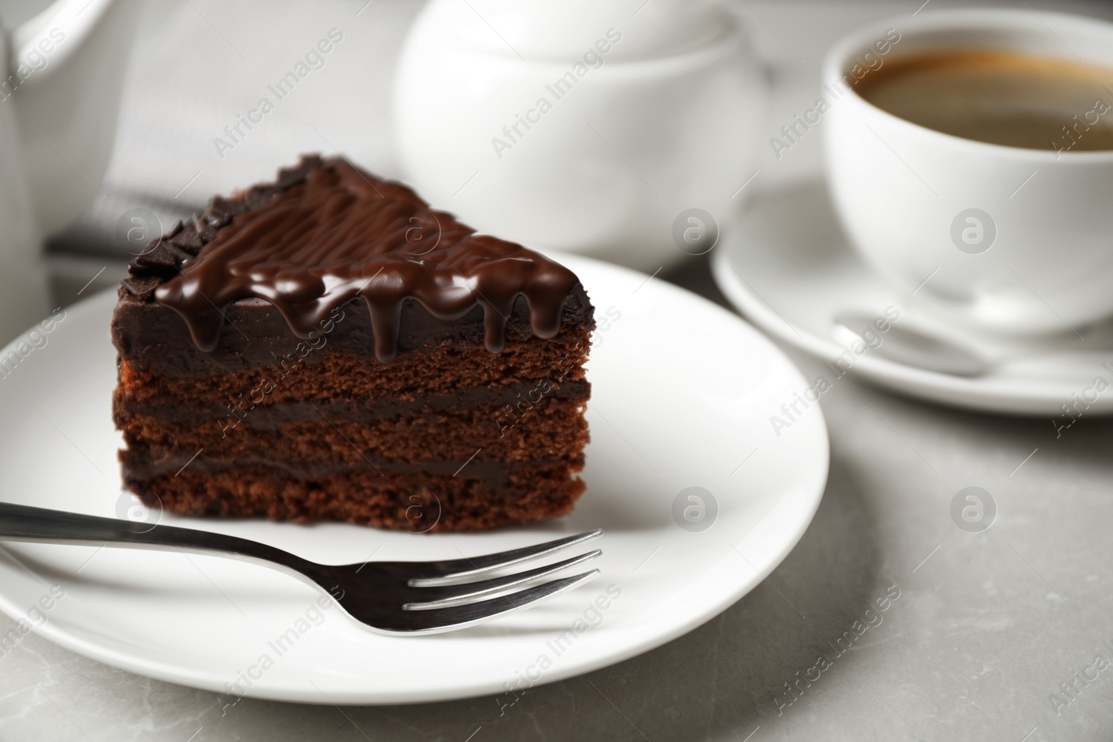 Photo of Tasty chocolate cake served on white table, closeup