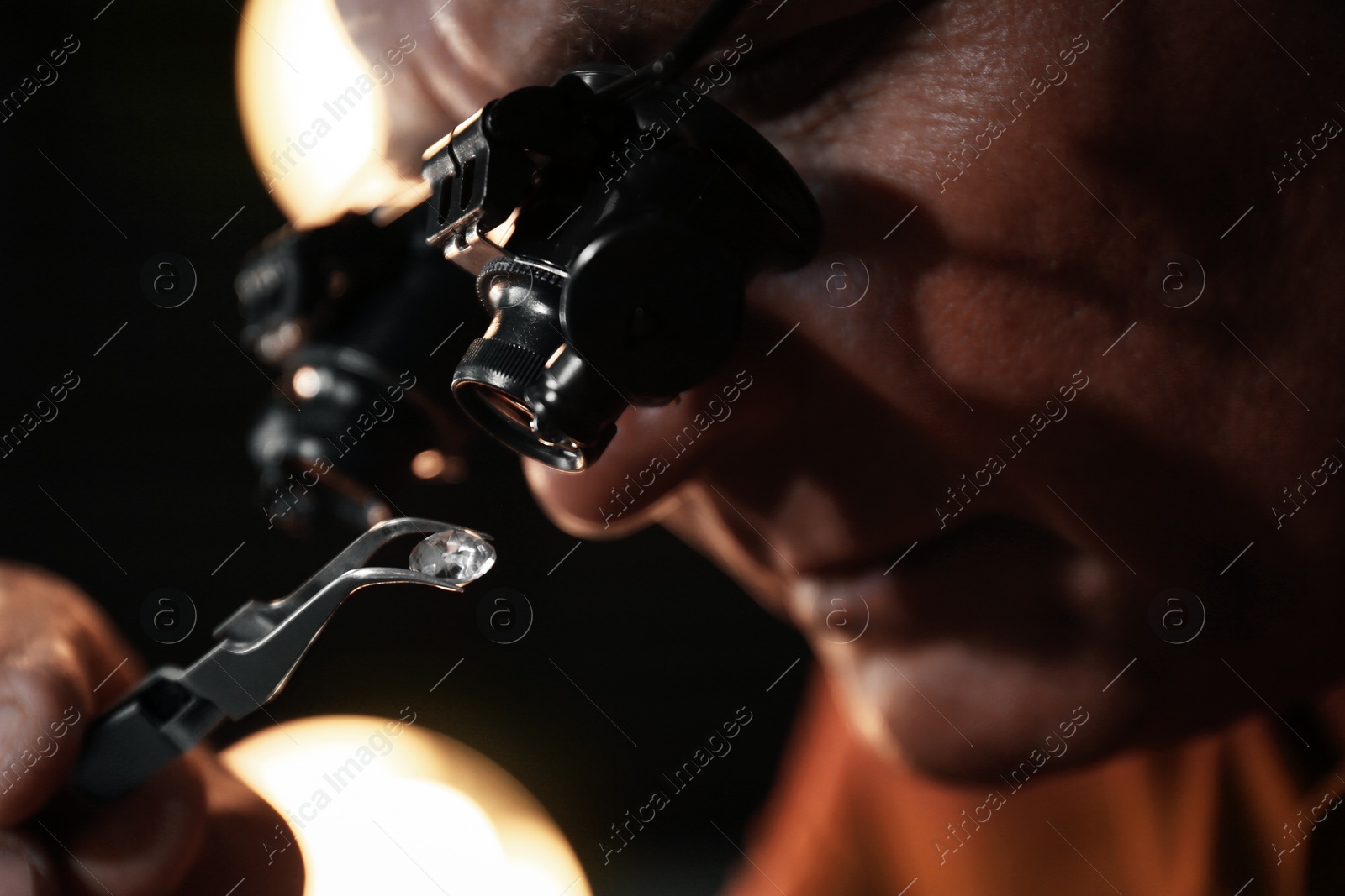 Photo of Professional jeweler evaluating beautiful gemstone, closeup view