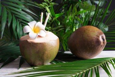 Fresh green coconuts on wooden table