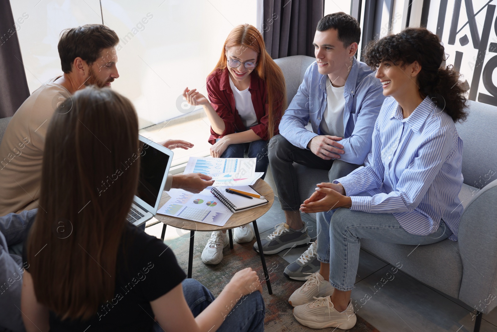 Photo of Team of employees working together in office. Startup project