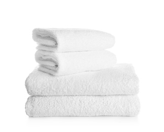 Stack of clean soft towels on white background