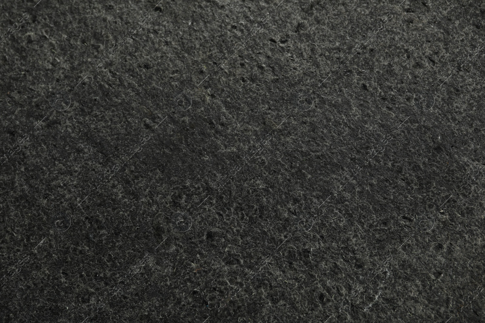 Photo of Texture of dark grey stone surface as background, closeup