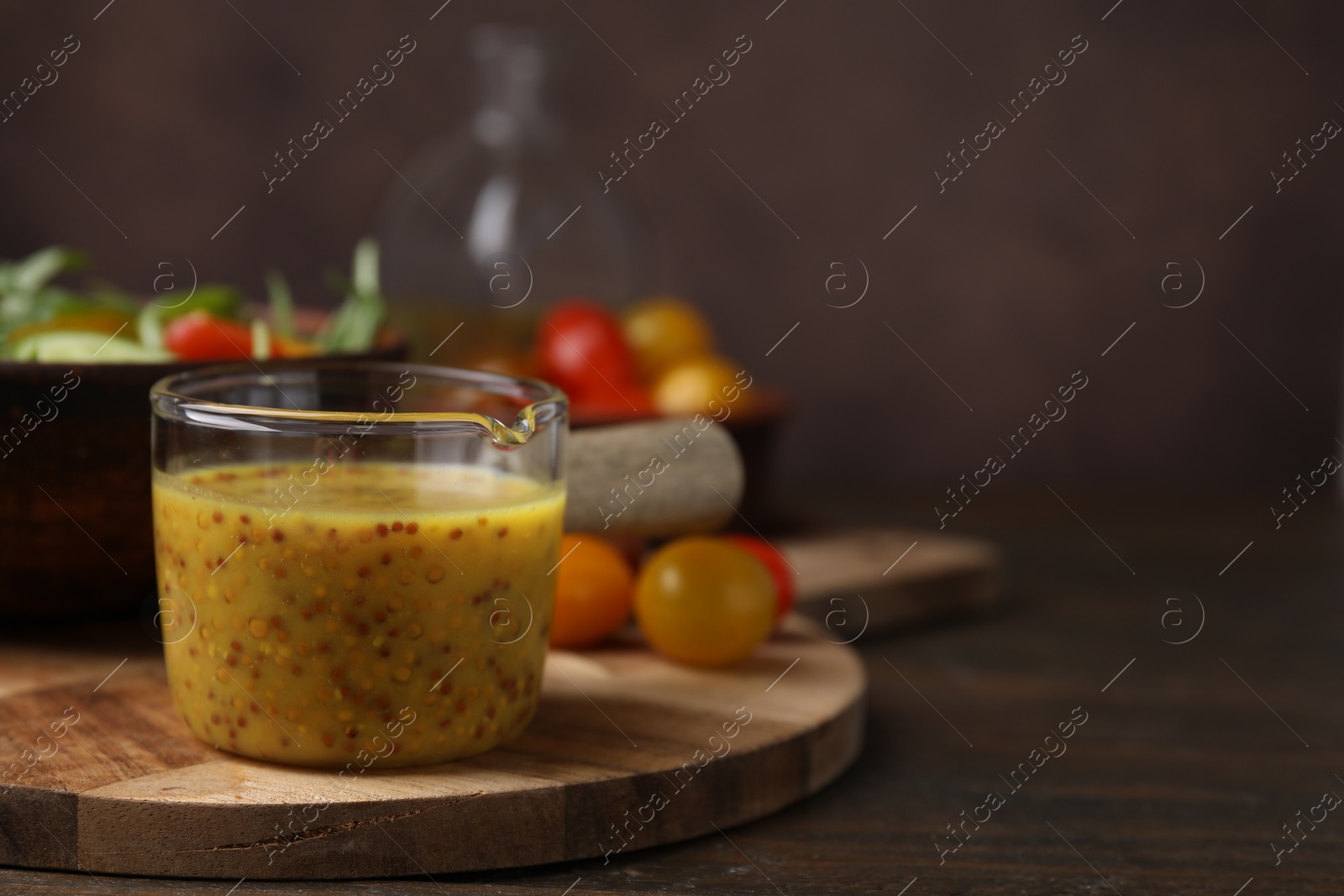 Photo of Tasty vinegar based sauce (Vinaigrette) on wooden table, closeup. Space for text