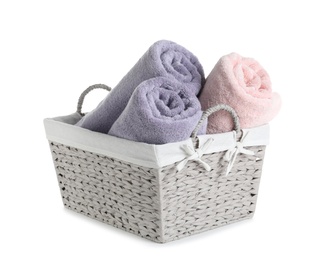 Photo of Basket with rolled towels isolated on white